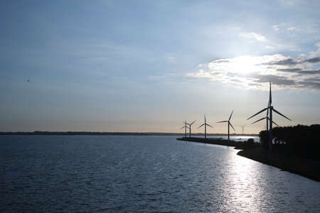 Offshore wind farm in the sundownの写真素材