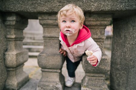 Portrait of little girl with ice creamの写真素材