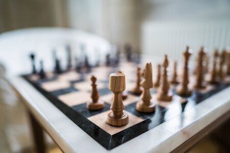 Wooden chess figures on stone fieldの写真素材