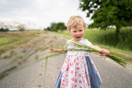 Little girl walking on country roadの写真素材