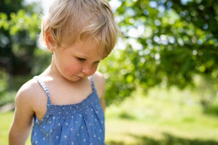 Little girl playing in gardenの写真素材