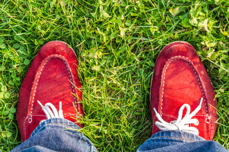 enjoying free day outdoors wearing red shoes, standing on green lawn in the country, freedom, happiness,の写真素材
