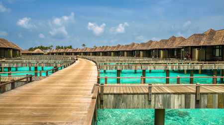 wooden path to the bungalows on irufushi island, maldivesのeditorial素材