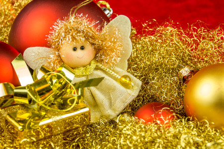 Christmas gift, angel and balls on gloden backgroundの写真素材
