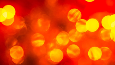 abstract red blurred background with golden bright circlesの写真素材