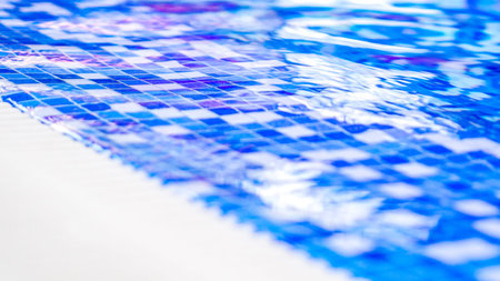 border of indoor pool with mosaic blue and white tiles