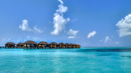 View of water bungalows in tropical paradise during a hot spring dayの写真素材