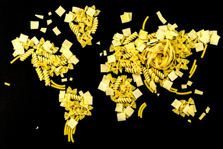 map of the world made of raw pasta on black backgroundの写真素材