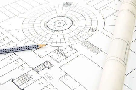 construction plan closeup with pencil and rolled paper