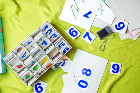 child is playing with numbers made of paperの写真素材