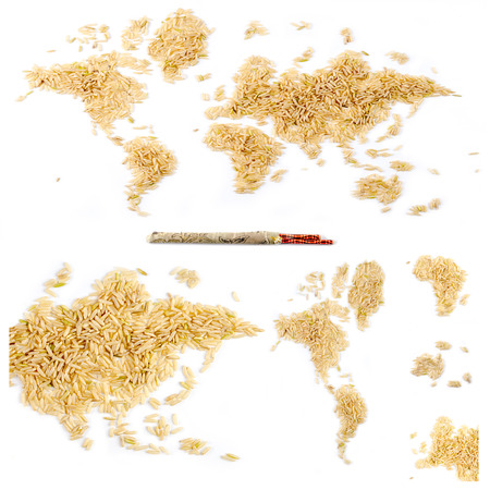 Map of the world made of raw natural rice on white background with chopsticks with separated continentsの写真素材
