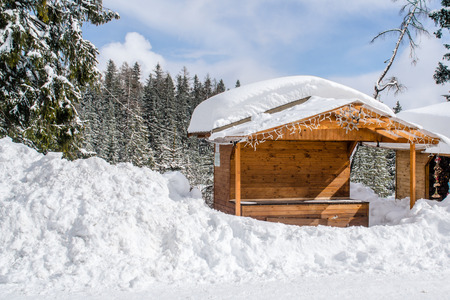 wooden hut covered with a lot of snow during christmas time in Europeのeditorial素材