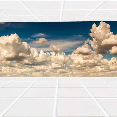 combination of white ceramic mosaic and blue sky full of cloudsの写真素材