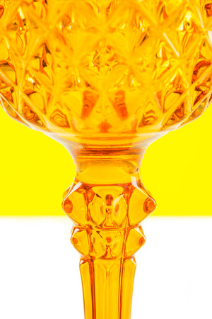 two orange glass on yellow and white background with one part defocusedの写真素材