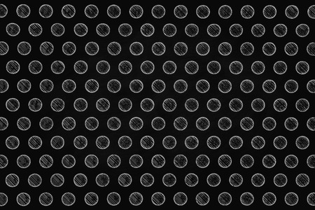 little white chalk holes on black smudged board backgroundの写真素材