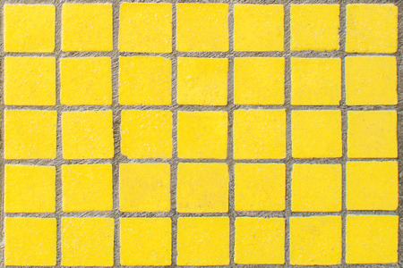 closeup of old yellow dirty mosaic with grey linesの写真素材