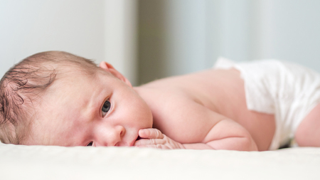 newborn child relaxing in bedの写真素材