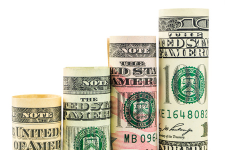 rising steps made of rolls of four most valued american dollar banknotes in one row on white backgroundの写真素材