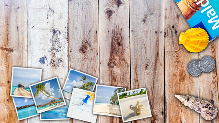 images from tropical island laying on wooden table with sea shell and tourist guideの写真素材