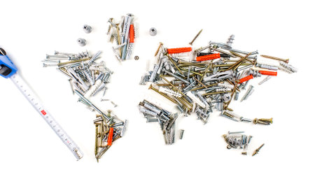 map of the world made of screws, fasteners and other mechanical tools with measuring tape on white...