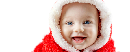 closeup of beautiful happy smiling baby boy in Santa dress with blue eyes on white backgroundの写真素材