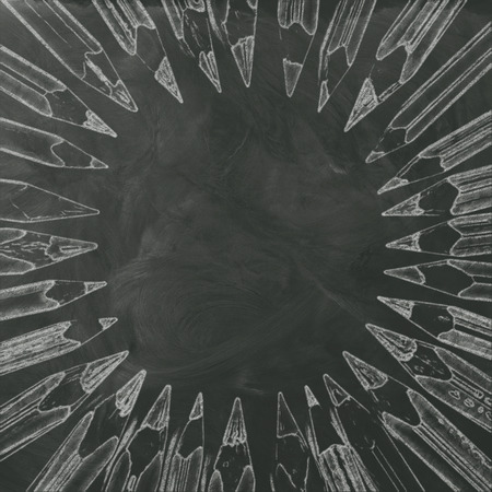 bunch of different pencils drawing forming circle on smudged black boardの写真素材