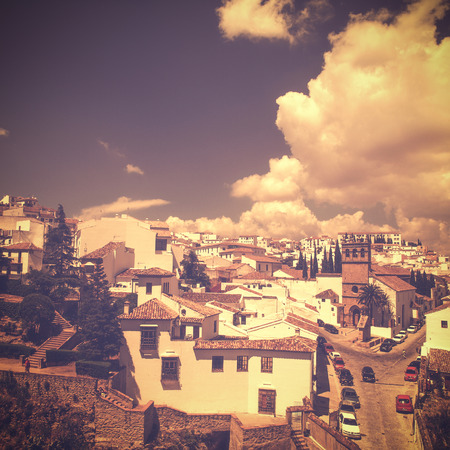 view of Ronda, Andalusia, Spain in vintage retro style with their typical architectue on hot summer day without peopleの写真素材