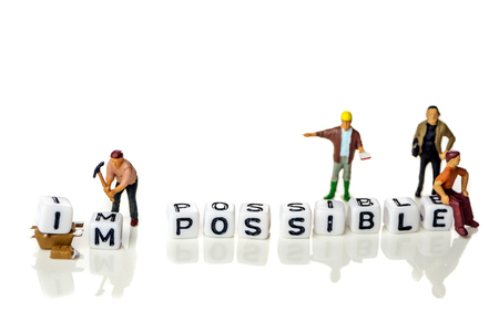 personal development and career growth or make possible concept in order to achieve set goals, white background with miniature figurines watching at itの写真素材