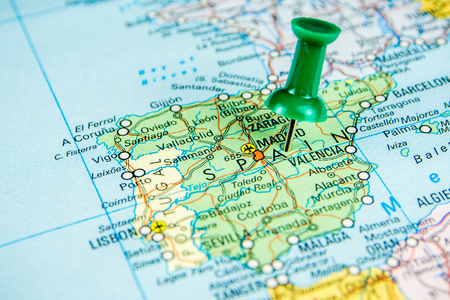 closeup of draw-pin stick into real map, travelling to Spain, identification of final destinationの写真素材