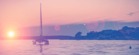 silhouette of a lonely yacht on sunset