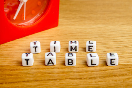 little miniature figurines with little dices forming specific word as a part of team meeting...