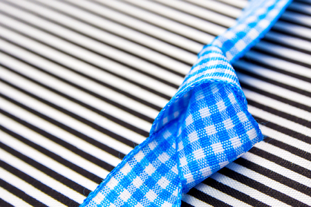 gift card textured background with blue bow in the middle and black lines with plenty copy space for the textの写真素材