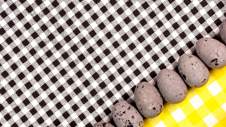 easter abstract gift card on black and white textured background with easter eggs  laying in row with plenty copy space for the textの写真素材