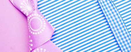 birthday gift card with violet bow and ribbon in the middle isolated and violet and blue background with plenty copy space for the textの写真素材