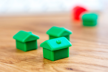closeup of small house using a magnifier, loupe as a buying new dreamy perfect house for meの写真素材
