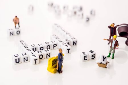 little white dices with black letters forming a crossword with the theme brexit, Great Britain exting European Union on white backgroundの写真素材