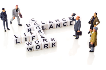 little white dices with black letters forming a crossword with the theme work life balance as...