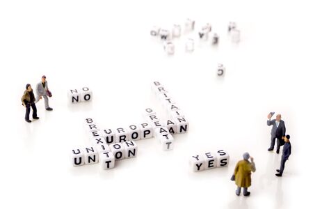 little white dices with black letters forming a crossword with the theme brexit, Great Britain exting European Union on white backgroundの写真素材