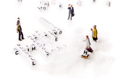 global climate change with planet warming and ice melting words in shape of white cubes with miniature workers figurines with black letters on white snowy backgroundの写真素材