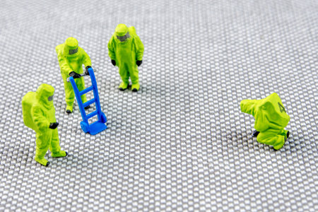 closeup of miniature figurines dressed like members of firemen special team interfering during gas...