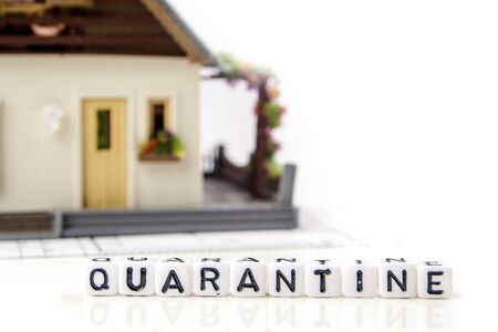the title made of miniature white dices with black letters of quarantine caused by very dangerous deadly corona virus type on white background, crosswords with the theme of quarantine with miniature figurinesの写真素材