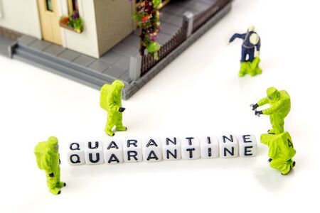 the title made of miniature white dices with black letters of quarantine caused by very dangerous deadly corona virus type on white background, crosswords with the theme of quarantine with miniature figurinesの写真素材