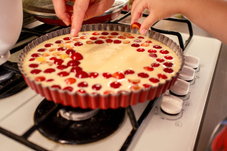 young boy is cooking and baking cherry pie with almond slices with his mamm