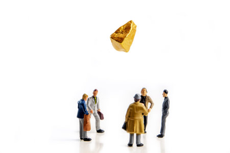 five business men miniature figuriens in a team meeting making an decision whether the gold or...