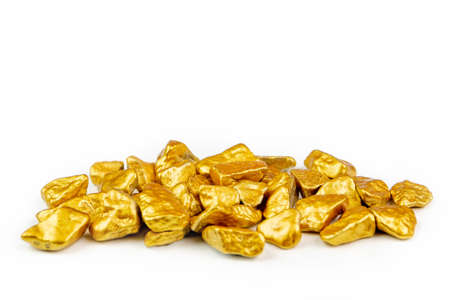view of a heap of golden nuggets, golden ore on white background isolated with plenty copy spaceの写真素材