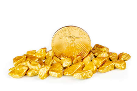 golden american eagle one ounce coin laying on a heap of golden nuggets, golden ore on white background isolated with plenty copy spaceの写真素材