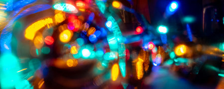 vibrant color blurred celebration dancing night lights in the city life may be used as party, birthday, christmas or night city life themed backgroundの写真素材