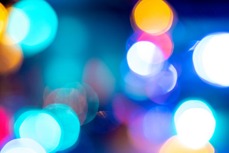 vibrant color blurred celebration dancing night lights in the city life may be used as party, birthday, christmas or night city life themed backgroundの写真素材