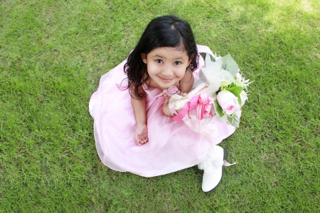 little girl sitting in the parkの写真素材
