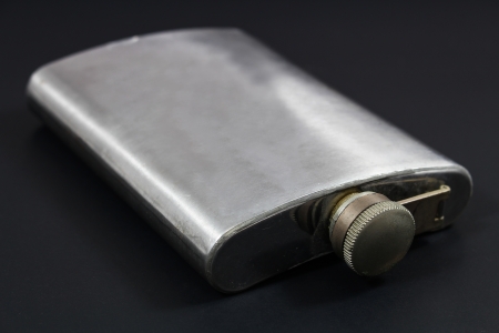 Stainless hip flask on black の写真素材